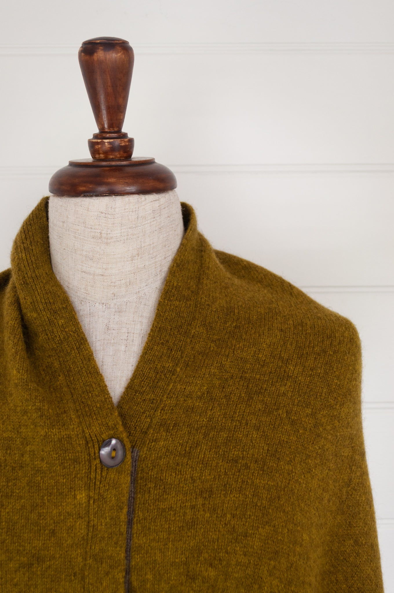Juniper Hearth baby yak wool poncho in Weed, a deep yellow olive green shade (close up).