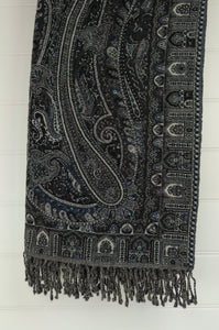 Juniper Hearth pure wool reversible tasseled throw rug with classic paisley design in charcoal, indigo and light grey.