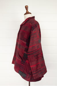 Neeru Kumar handwoven wool Cora jacket in irrgular checks and stripes in shades of red, buton up, self collar, inset front pockets, slight A-line swing shape.