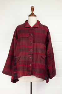 Neeru Kumar handwoven wool Cora jacket in irrgular checks and stripes in shades of red, buton up, self collar, inset front pockets, slight A-line swing shape.
