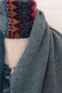 Eribé Alloa scarf with colour blocking, fairisle and fringed edging. Lugano Rose in teal green and pink