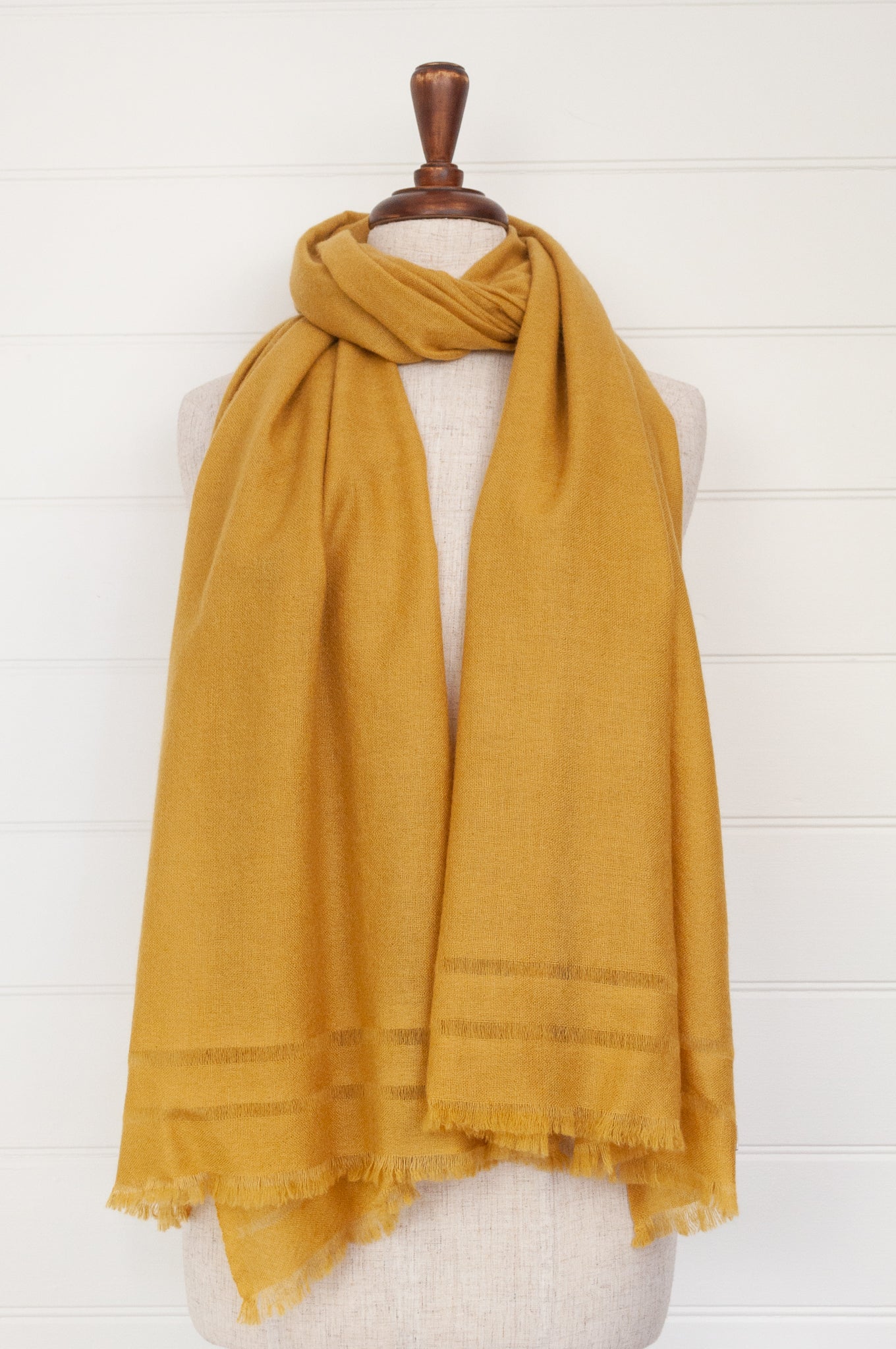 Juniper Hearth woven cashmere scarf featuring fagoting detail and fringed at ends, in soft gold mustard.