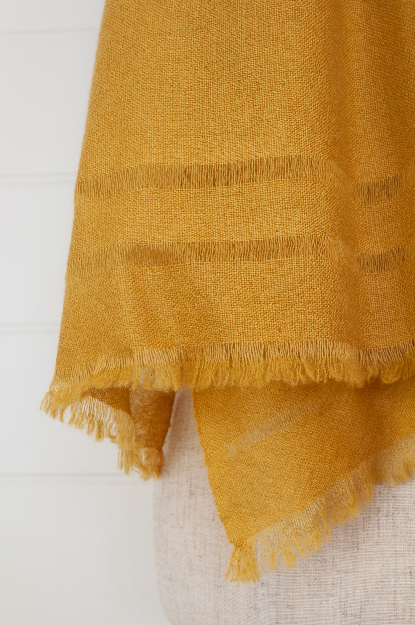 Juniper Hearth woven cashmere scarf featuring fagoting detail and fringed at ends, in soft gold mustard.