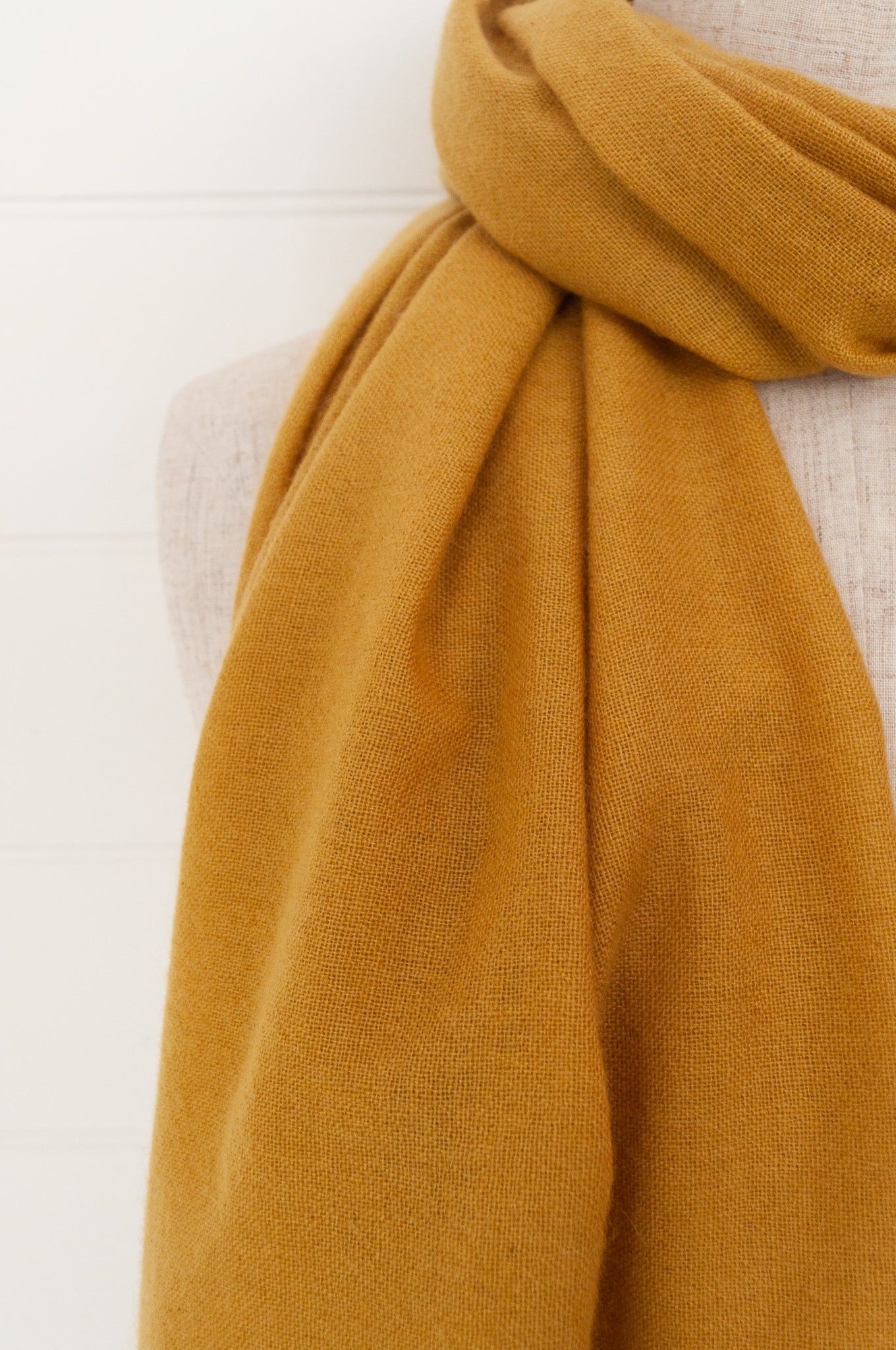 Juniper Hearth woven cashmere scarf featuring fagoting detail and fringed at ends, in soft gold mustard.