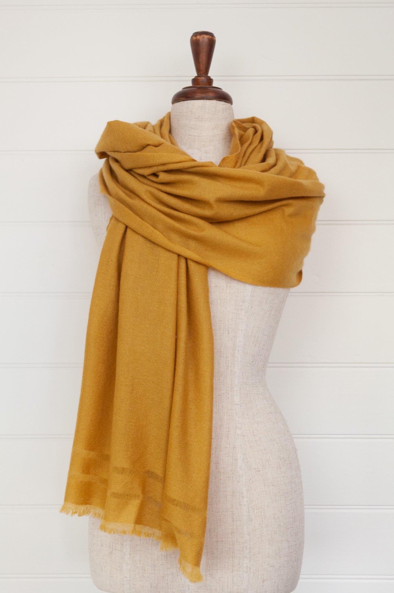 Juniper Hearth woven cashmere scarf featuring fagoting detail and fringed at ends, in soft gold mustard..