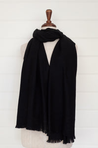 Juniper Hearth woven cashmere scarf featuring fagoting detail and fringed at ends, in black.