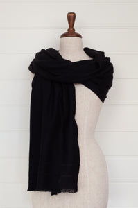 Juniper Hearth woven cashmere scarf featuring fagoting detail and fringed at ends, in black.