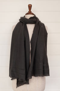 Juniper Hearth woven cashmere scarf featuring fagoting detail and fringed at ends, in charcoal.