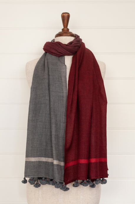 Juniper Hearth woven merino wool scarf, lightweight and very soft, melange dye from charcoal to cherry red, with handmade pompoms.