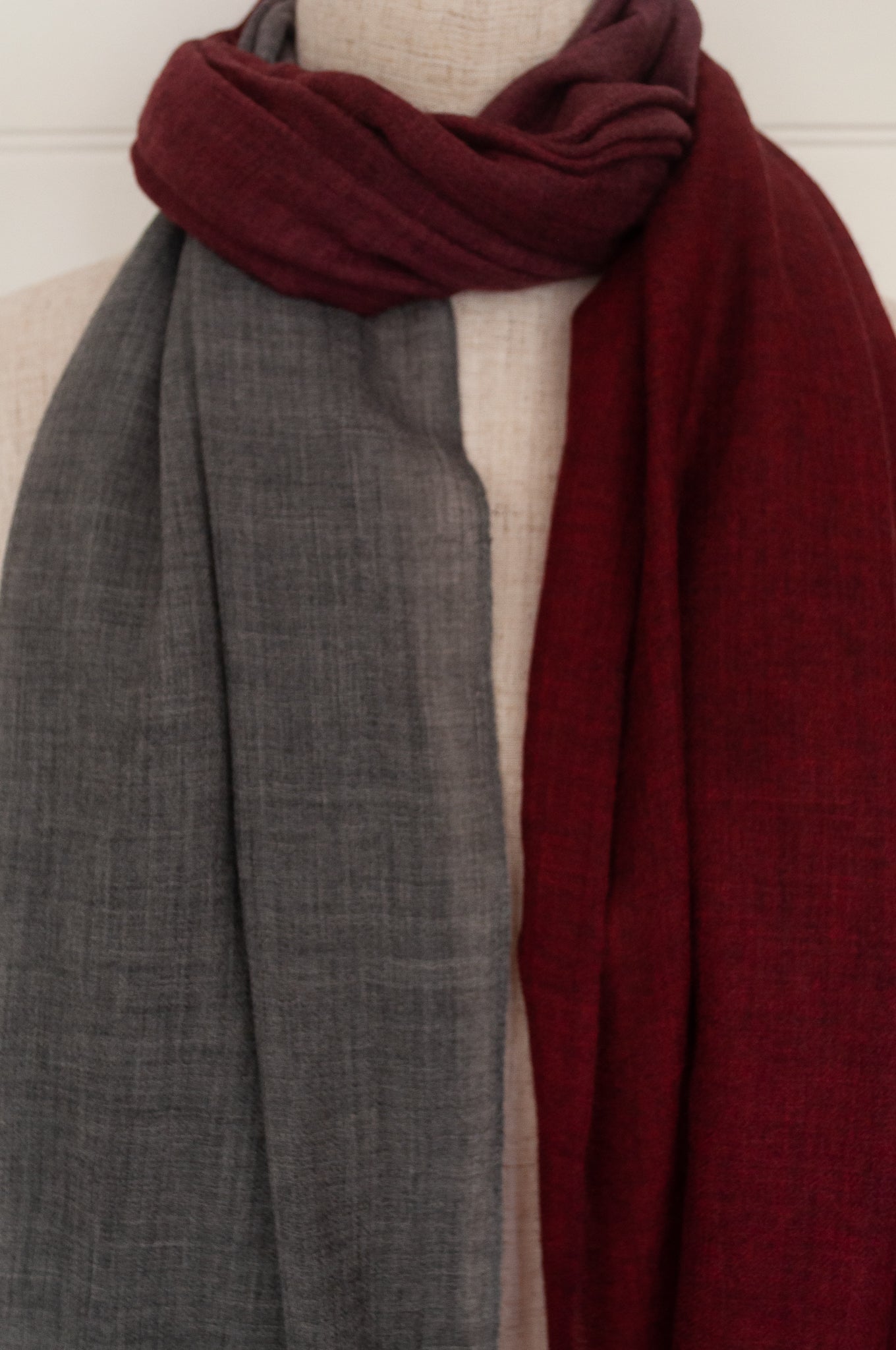 Juniper Hearth woven merino wool scarf, lightweight and very soft, melange dye from charcoal to cherry red, with handmade pompoms.