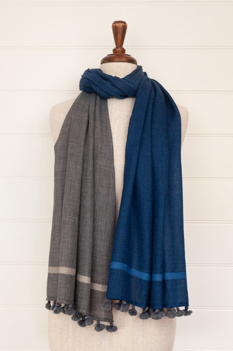 Juniper Hearth woven merino wool scarf, lightweight and very soft, melange dye from charcoal to sapphire blue, with handmade pompoms.