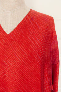 Neeru Kumar Petria dress in pink orange vermillion red silk shibori. A-line three quarter sleeve tunic dress  with V-neck includes slip.
