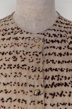 Load image into Gallery viewer, Raga Betony silk shibori shirt, natural black on natural linen, collarless button up, three quarter sleeves, pin tucked back yoke (close up).