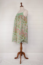 Load image into Gallery viewer, Ethically made pure cotton voile summer nightdress with adjustable straps and pintucked yoke, this nightie is in a mint green floral print with broderie edging (side view).