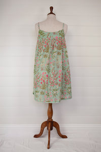 Ethically made pure cotton voile summer nightdress with adjustable straps and pintucked yoke, this nightie is in a mint green floral print with broderie edging (back view).