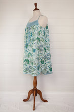 Load image into Gallery viewer, Ethically made pure cotton voile summer nightdress with adjustable straps and pintucked yoke, this nightie is in a blue floral print with broderie edging (side view).