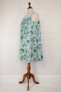 Ethically made pure cotton voile summer nightdress with adjustable straps and pintucked yoke, this nightie is in a blue floral print with broderie edging (side view).