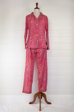 Load image into Gallery viewer, Ethically made cotton voile pyjamas with garden flowers of pink, red and vanilla on a deep raspberry pink red background.