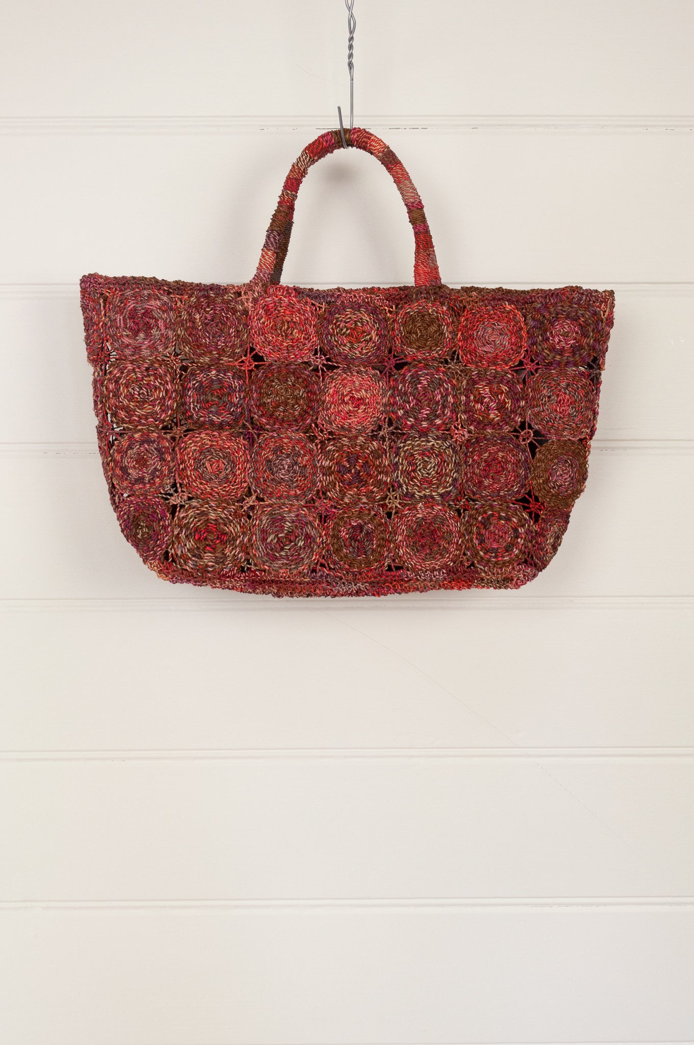 Sophie Digard handmade medium sized macrame raffia bag in shades of red.