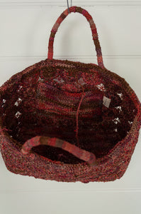 Sophie Digard handmade medium sized macrame raffia bag in shades of red.
