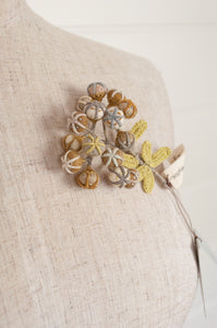 Sophie Digard hand made embroidered and crocheted linen flower brooch in Glimmer palette, soft cool neutrals.