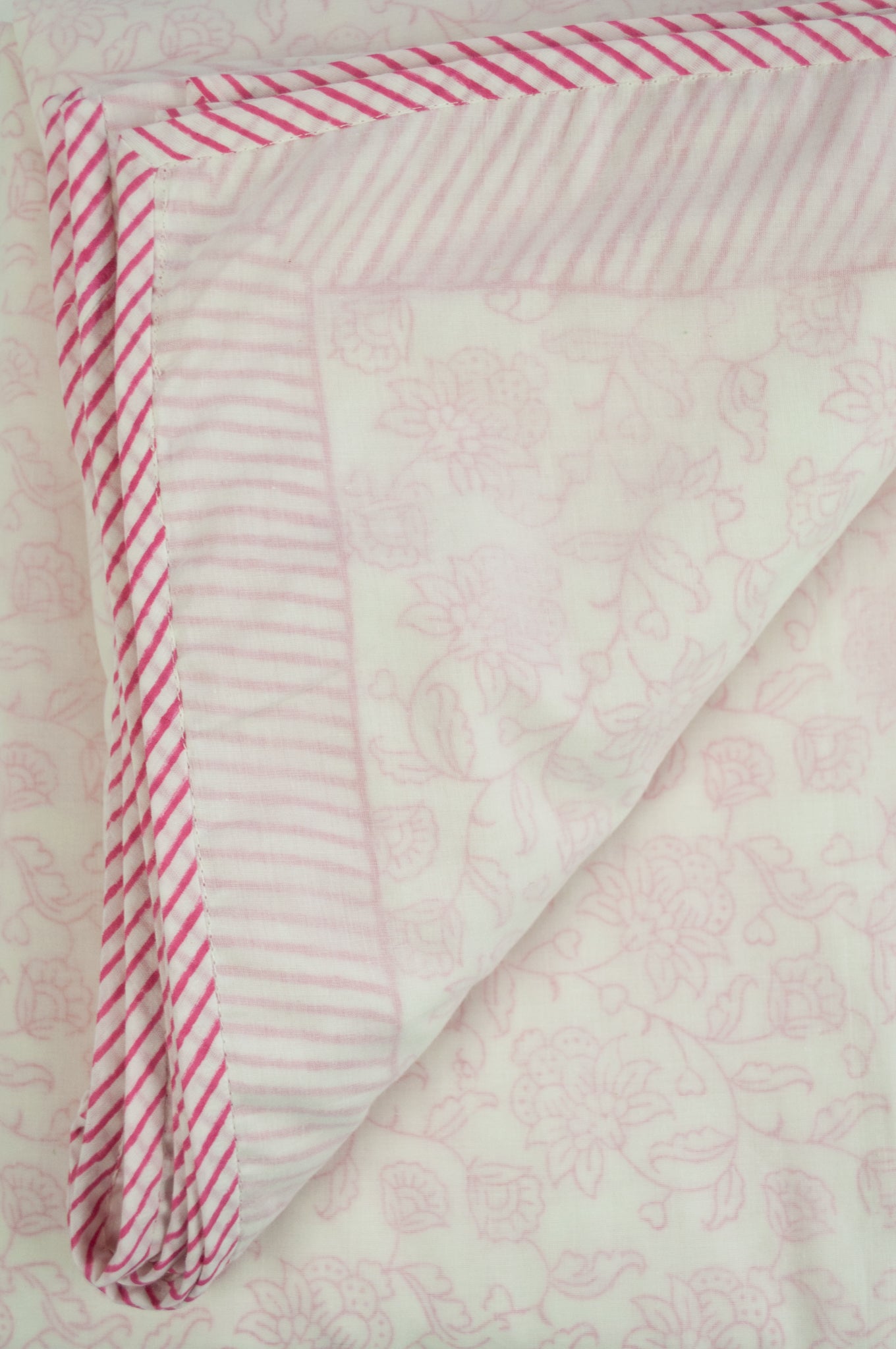 Summer quilt dohar lightweight muslin cotton voile quilt, block printed three layers, rose pink floral print on white with striped border.