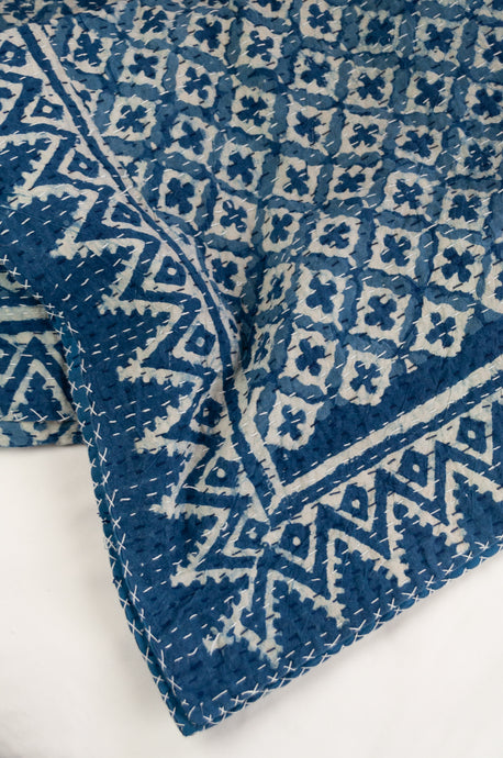 Block printed in indigo, blue and white kantha quilt hand made in Jaipur, featuring two tone checks and crosses pattern and decorative border.