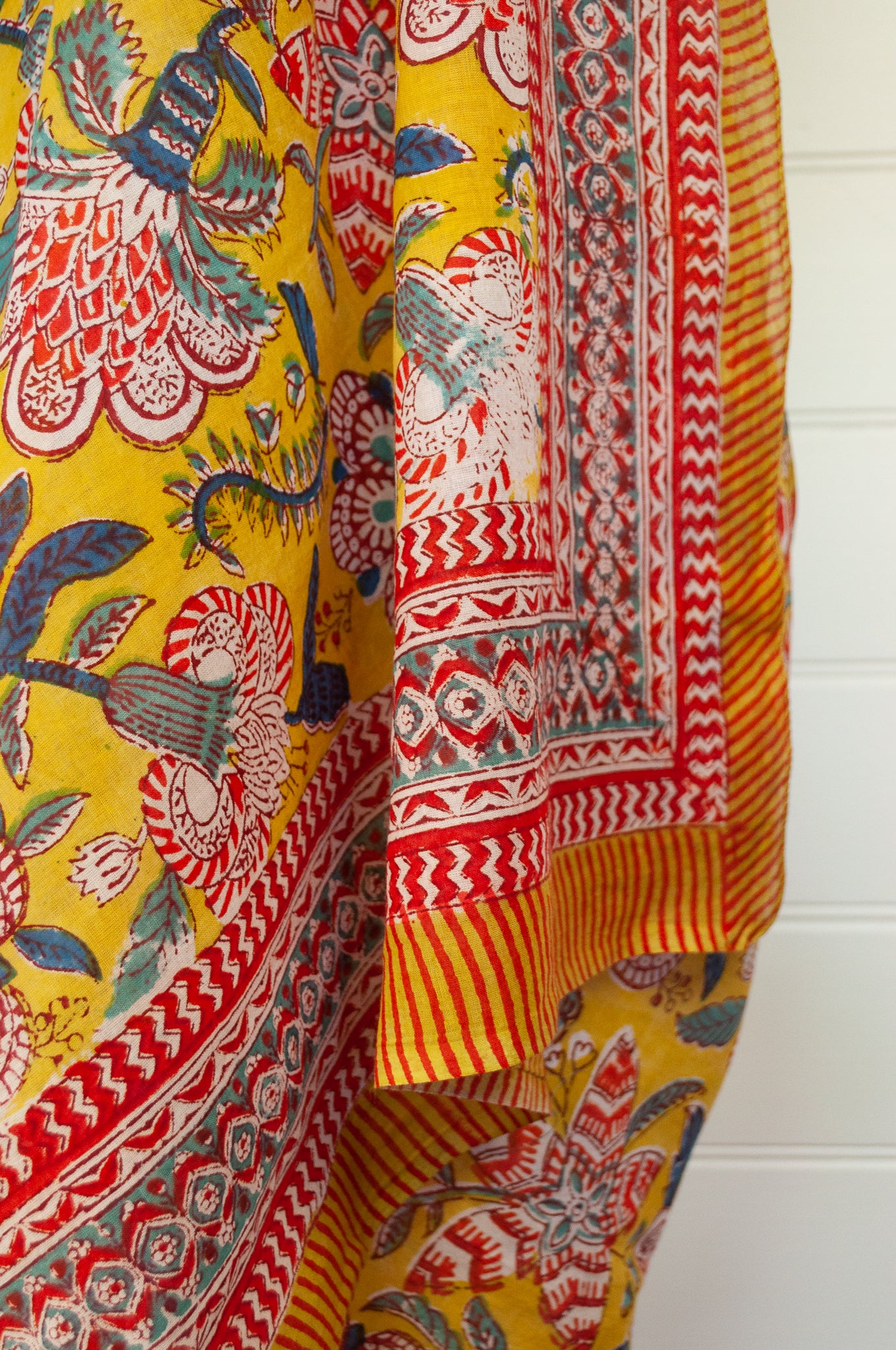 Cotton voile blockprint sarong, colourful floral on mustard yellow.