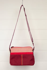 Anna Kaszer Paris Presto bag in Malva, compact size with flat base, red and ecru print print trim on deep red body, adjustable cross border shoulder strap.