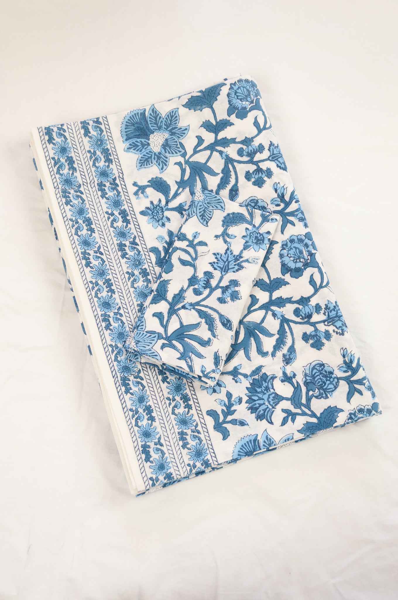 Cotton tablecloth, blockprinted by hand exclusively for Juniper Hearth, Mina floral in shades of denim blue on white.