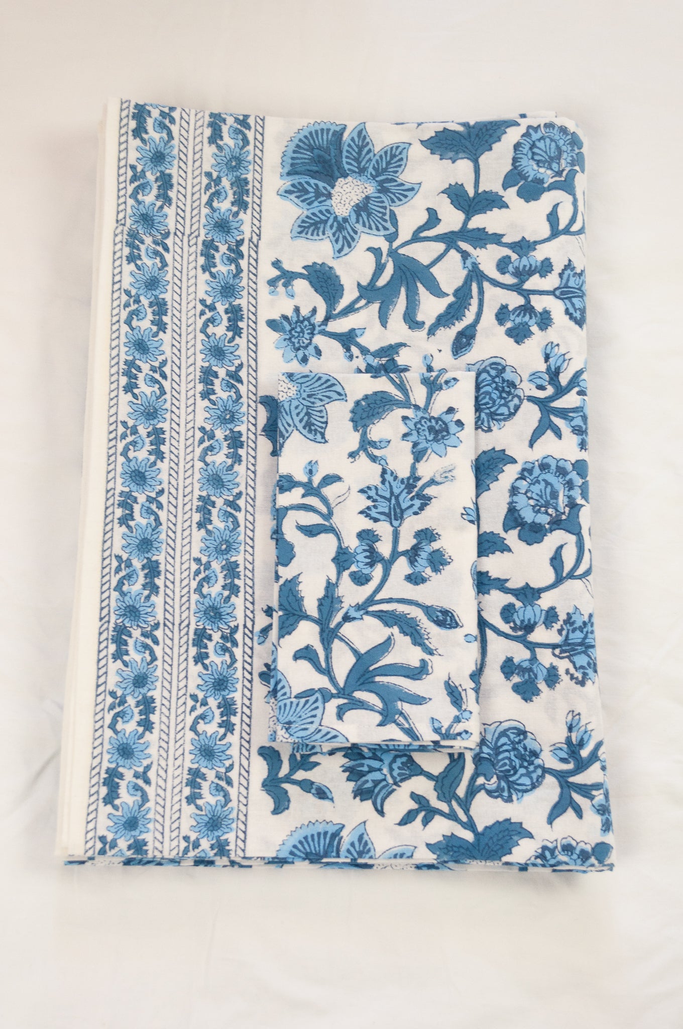Cotton tablecloth, blockprinted by hand exclusively for Juniper Hearth, Mina floral in shades of denim blue on white.