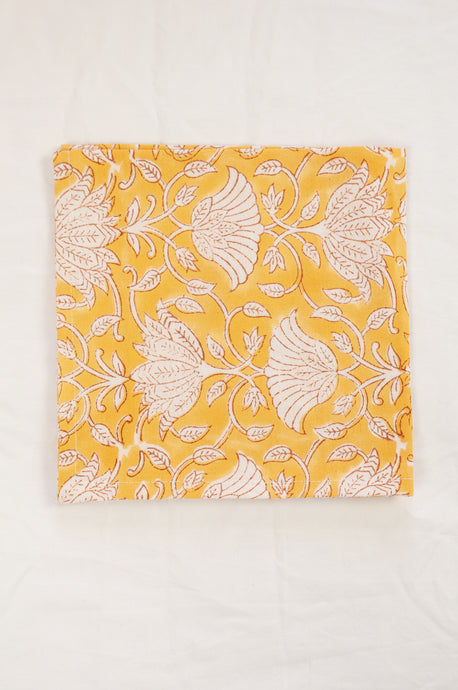 Cotton table napkins, blockprinted by hand exclusively for Juniper Hearth, Sara floral in white on honey yellow.