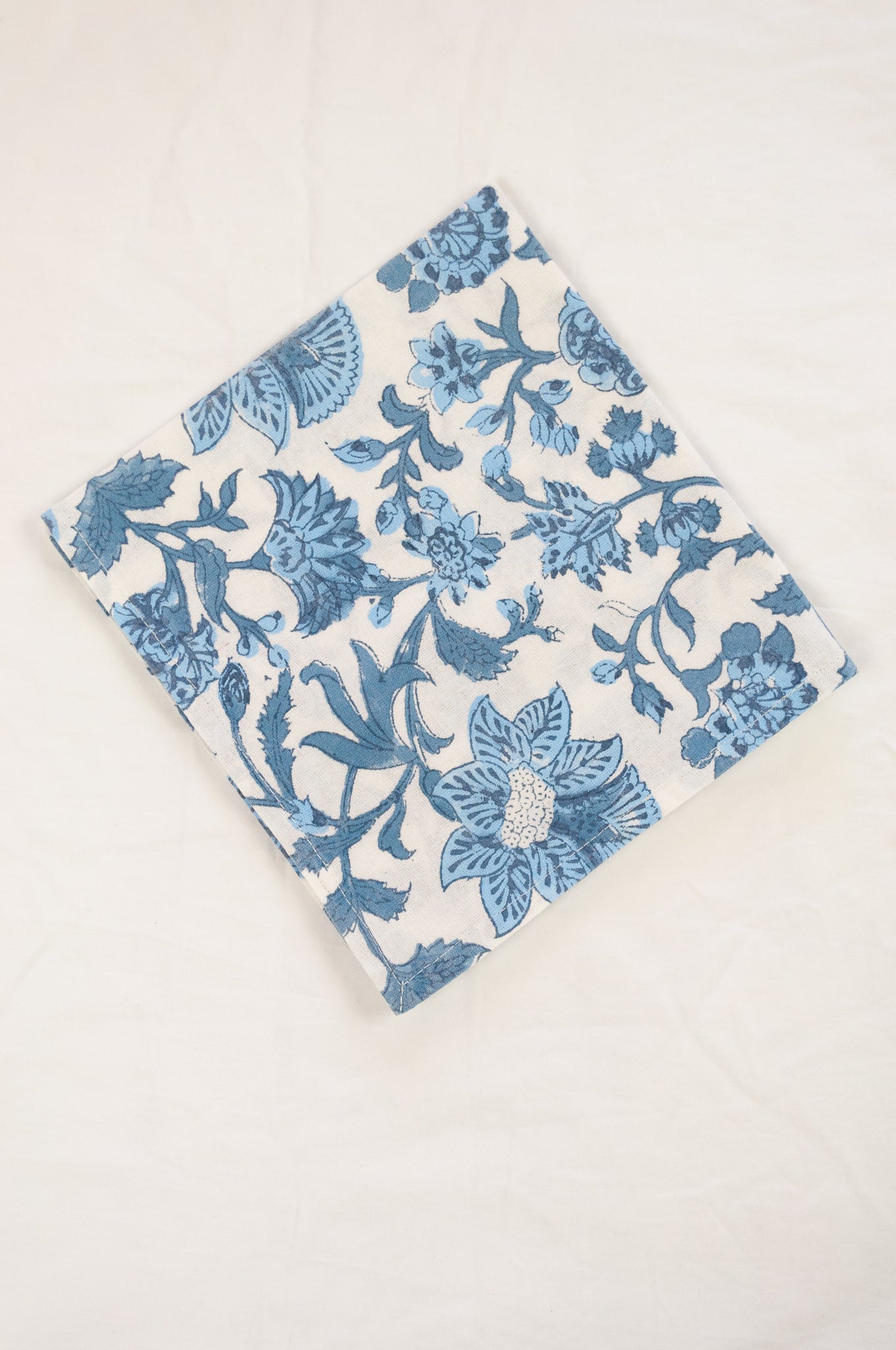 Cotton table napkins, blockprinted by hand exclusively for Juniper Hearth, Mina floral in shades of denim blue on white.