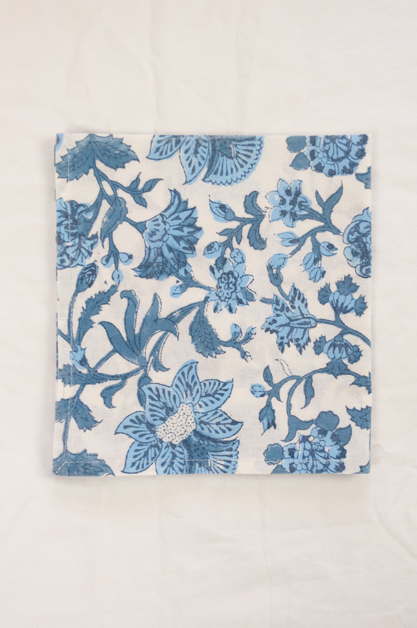 Cotton table napkins, blockprinted by hand exclusively for Juniper Hearth, Mina floral in shades of denim blue on white.