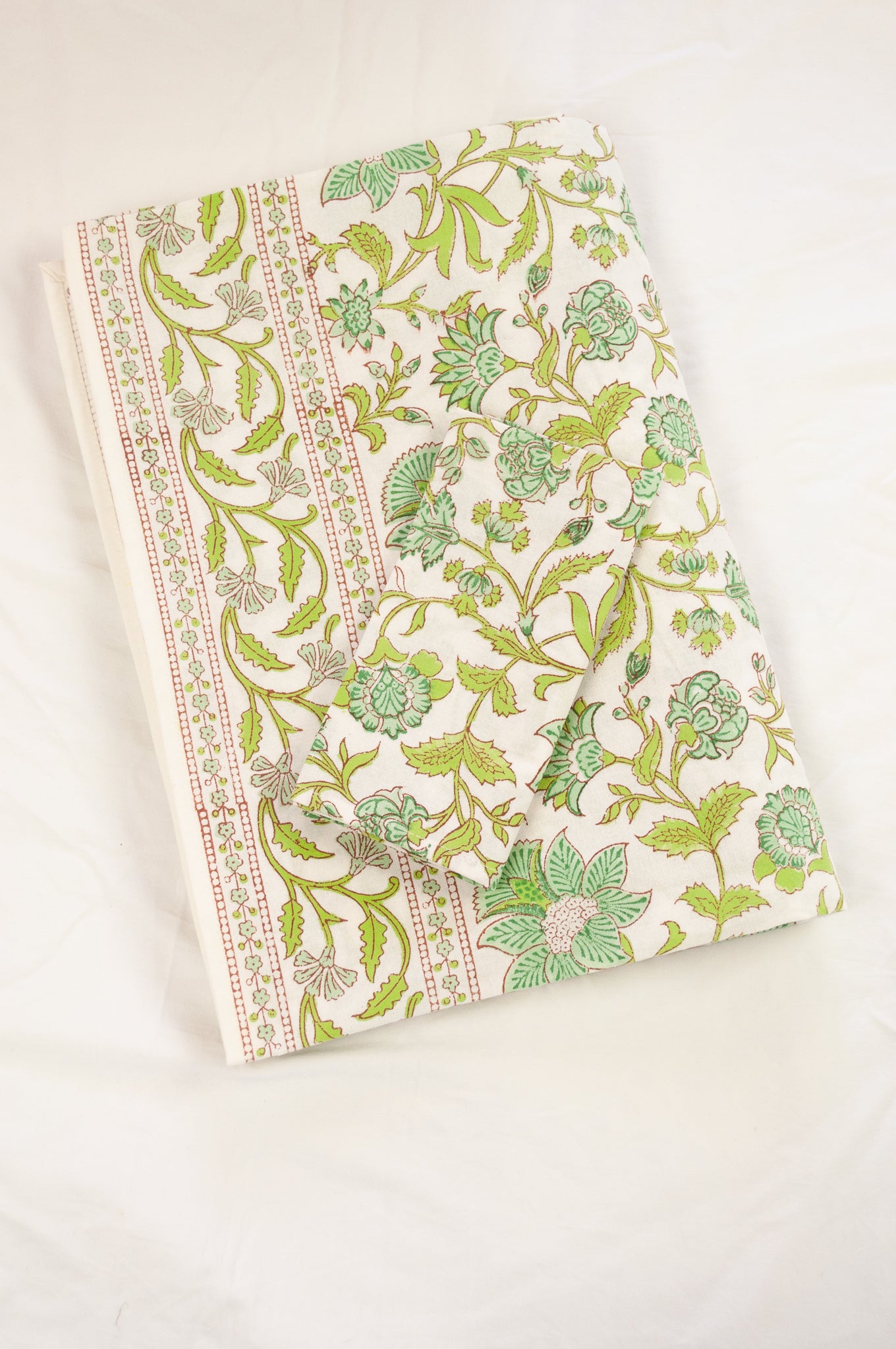 Cotton table cloth, blockprinted by hand exclusively for Juniper Hearth, Mina floral in turquoise and lime green on white.