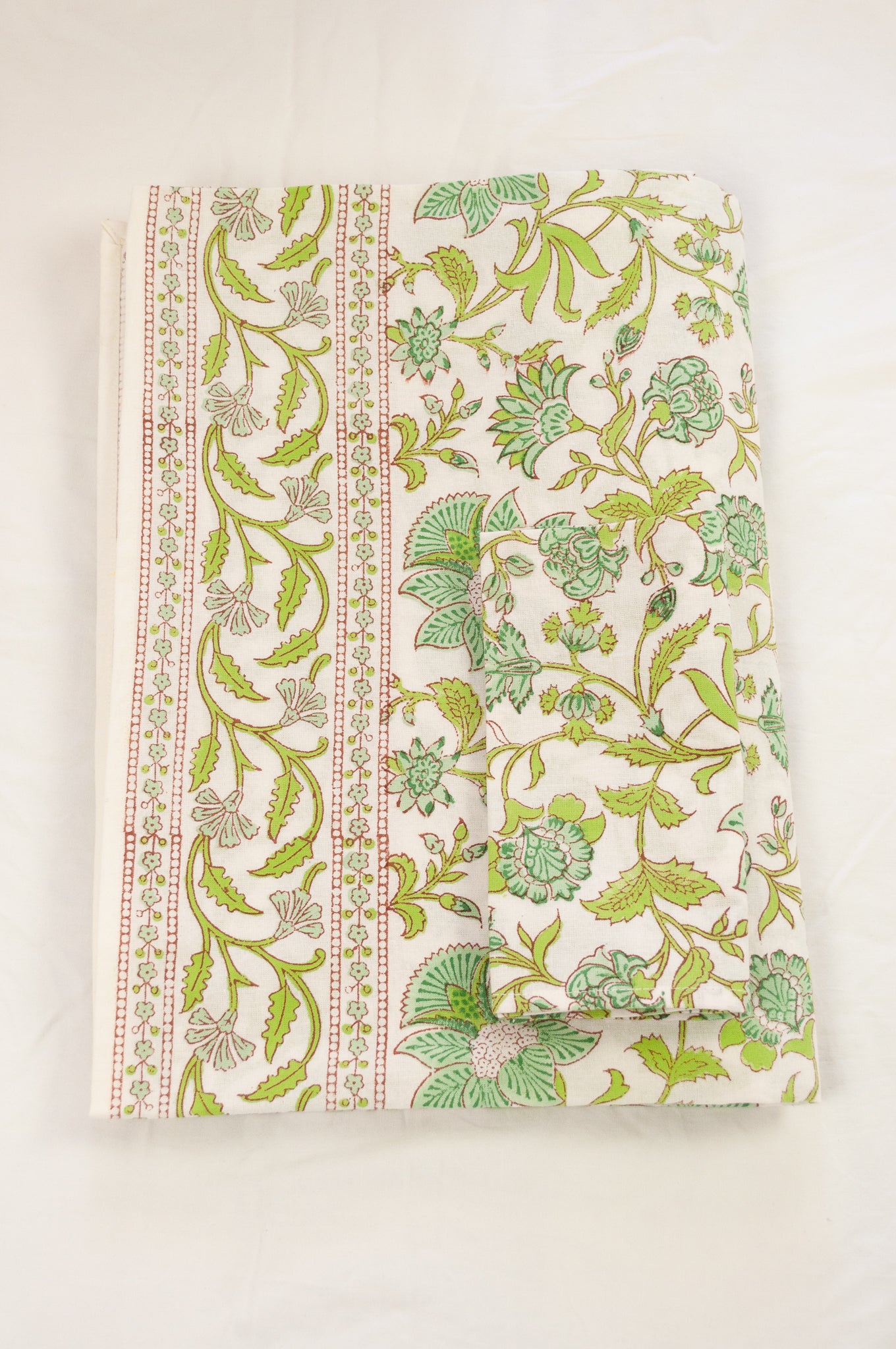 Cotton table cloth, blockprinted by hand exclusively for Juniper Hearth, Mina floral in turquoise and lime green on white.