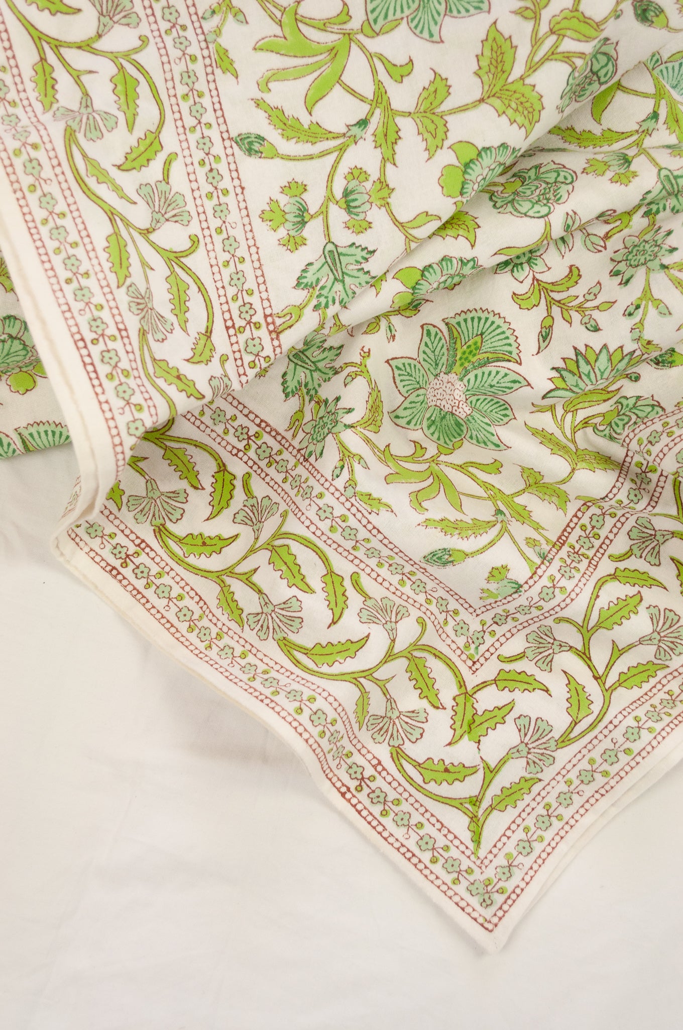 Cotton table cloth, blockprinted by hand exclusively for Juniper Hearth, Mina floral in turquoise and lime green on white.