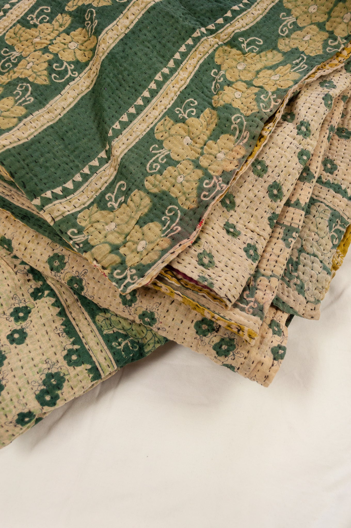 Vintage kantha quilt upcycled from cottonn saris, handstitched, in soft mustard yellow floral with magenta border, green and ecru floral on the reverse.