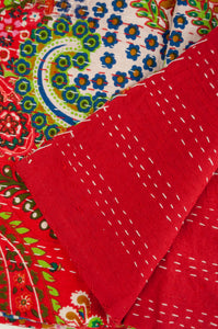 Handstitched cotton kantha quilt, a colourful paisley on a brilliant red background, with highlights in lime, emerald, turquoise, white, and tan