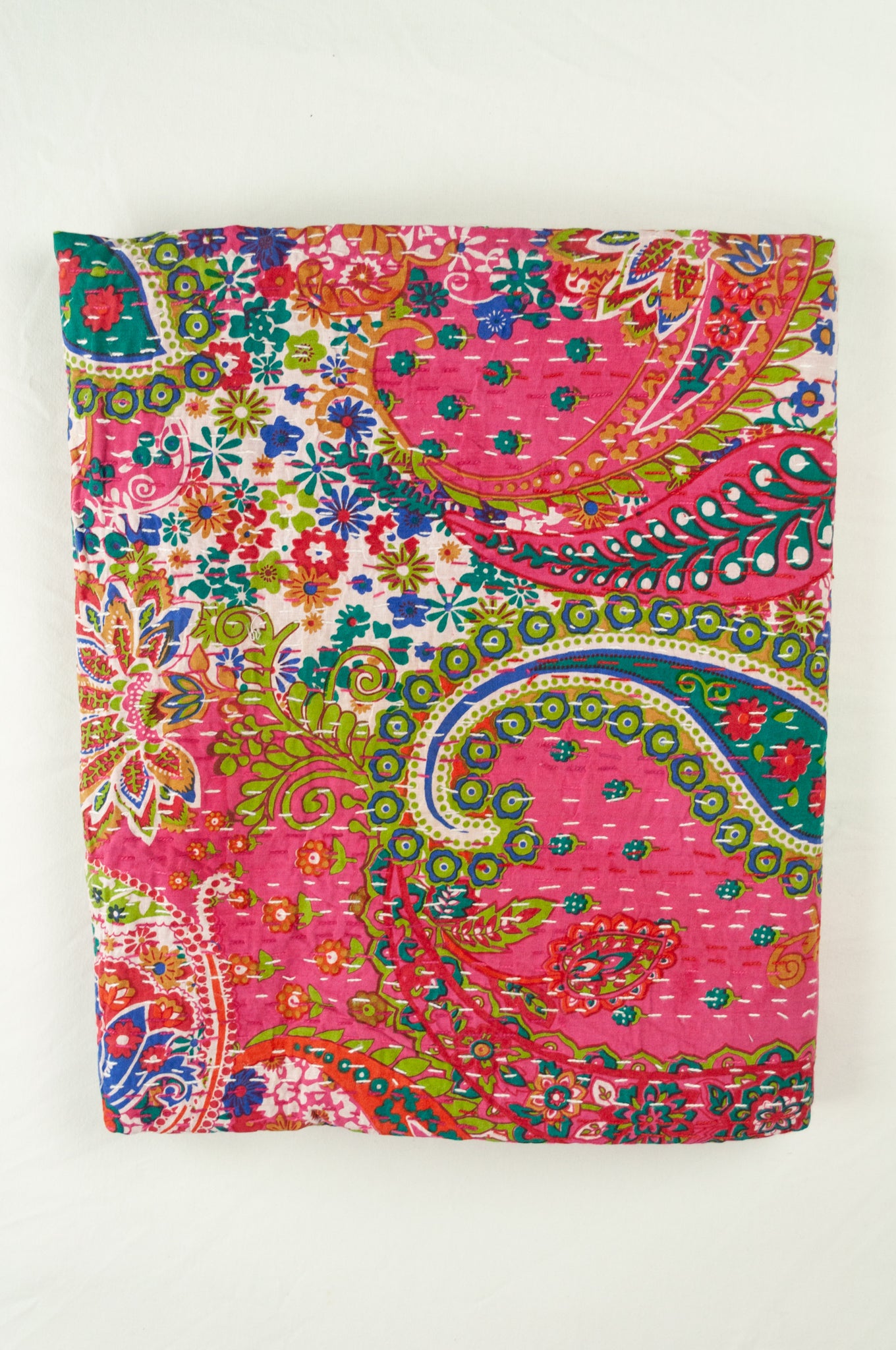 Handstitched cotton kantha quilt, a colourful paisley on a deep pink background, with highlights in lime, emerald, turquoise, white, and tan