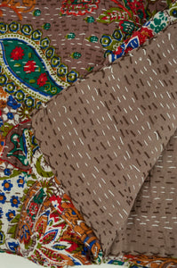 Handstitched cotton Kantha quilt paisley on a chocolate brown background, with highlights in olive green, red, blue, tan and white.