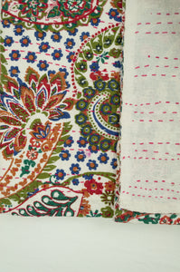 Handstitched cotton Kantha quilt paisley on a white background, with highlights in olive green, emerald, red, navy blue and tan