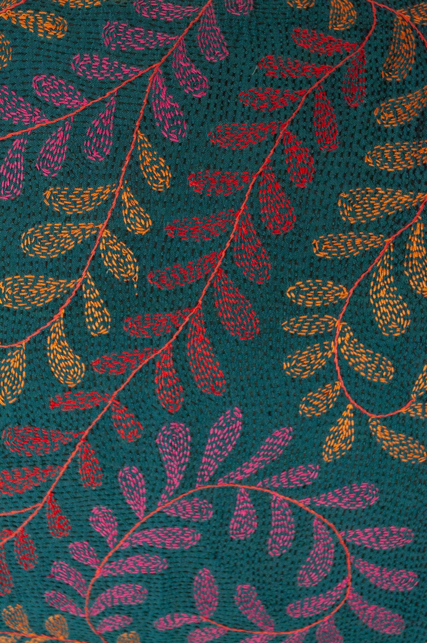 Kantha stitched on vintage silk, this square cushion features an allover tracery of vine leaves in cherry red, rose pink and apricot on a black stitched teal blue background
