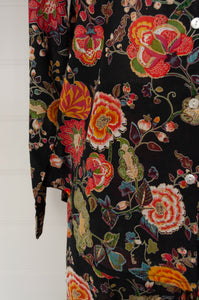 Ethically made cotton voile pyjamas, tropical print of red, gold and orange flowers on black background.