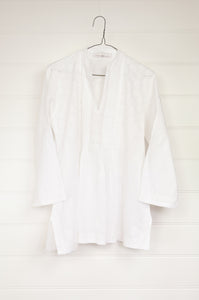 White on white chikankari embroidered pintucked blouse.