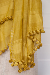 Silk cotton pompom scarf in mustard yellow.