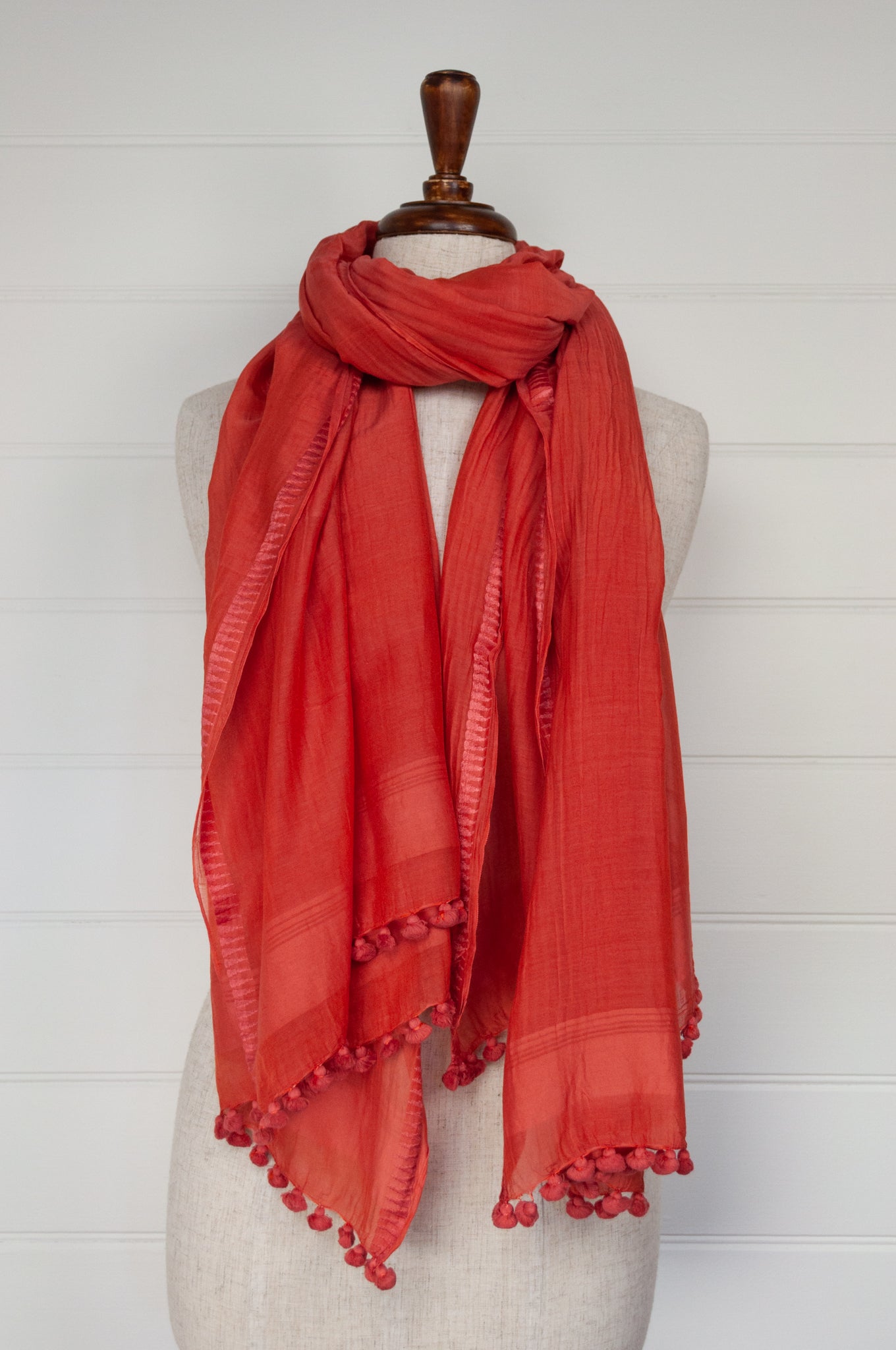 Silk cotton pompom scarf in tangerine orange.