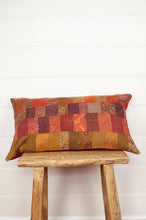 Load image into Gallery viewer, Vintage silk patchwork kantha bolster cushion in shades of orange, rose, burgundy, floral prints and highlights of lilac purple and olive green.