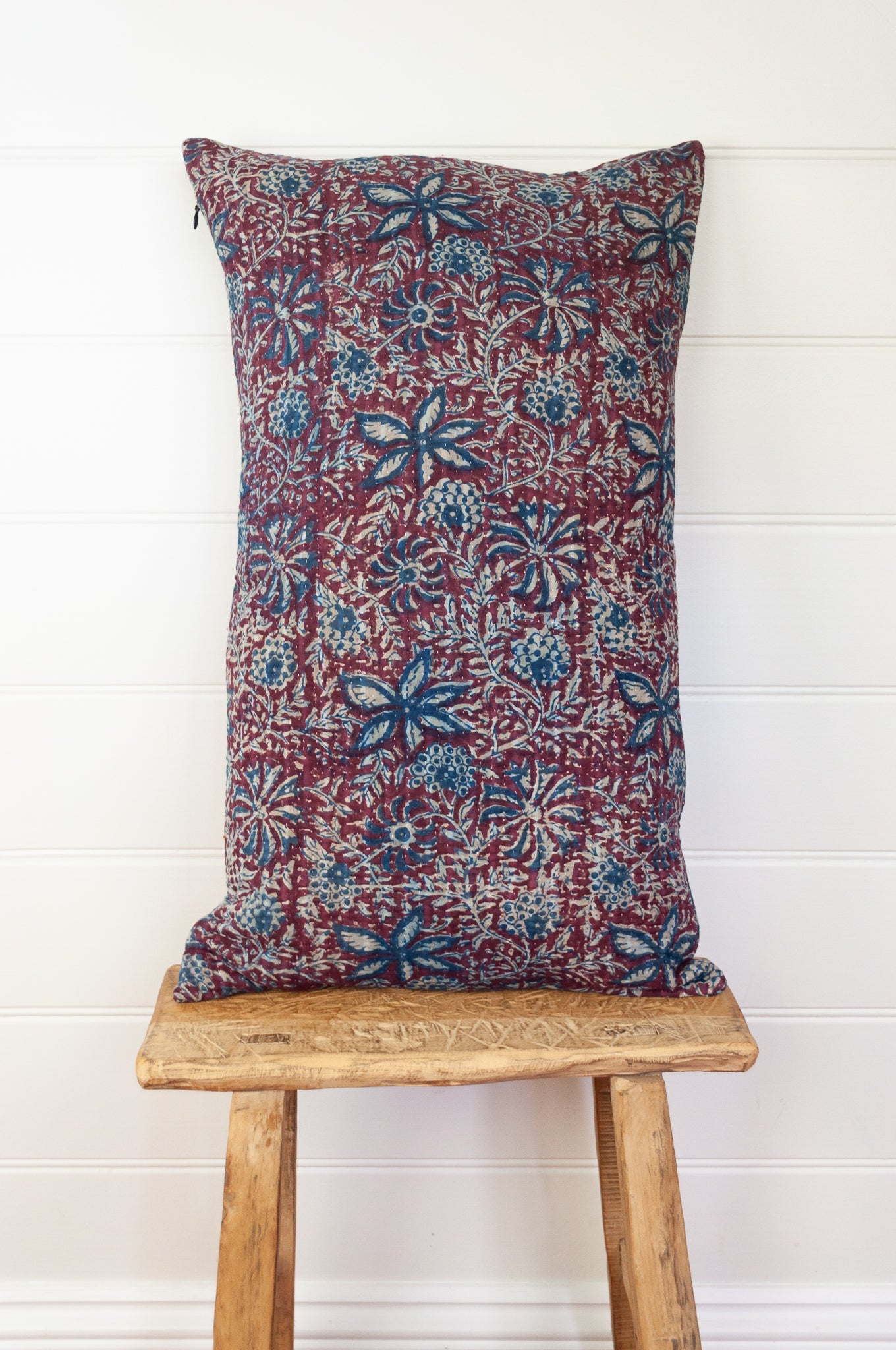 Vintage kantha oblong rectangular bolster cushion blockprinted with floral design in indigo and deep burgundy red.