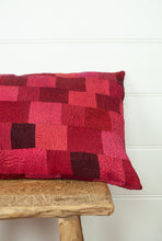 Load image into Gallery viewer, Vintage silk patchwork kantha bolster cushion is in rich tones of rose pink and red, with a dash of magenta